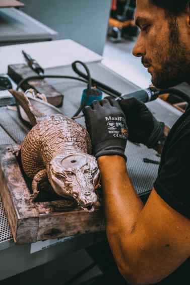 A studio assistent working on the sculpture "Happily Ever After" in Klibansky's Studio - Happily Ever After (bronze), 2018 by Joseph Klibansky