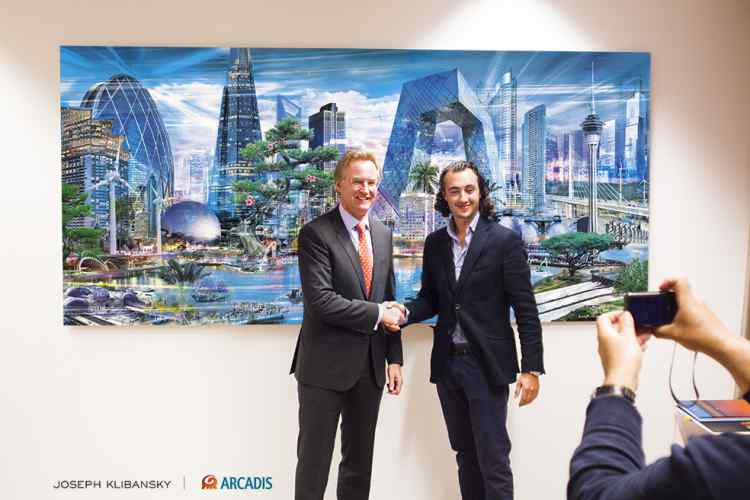 Joseph Klibansky shaking the had of Niel McArtny (CEO Arcadis) at the unveiling of the special uneque commissioned adword for the 25th aniversary of Arcadis - About Arcadis