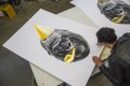 Joseph signing and numbering a large Big Bang screen print. - Big Bang (edition, black/gold leaf), 2016 by Joseph Klibansky