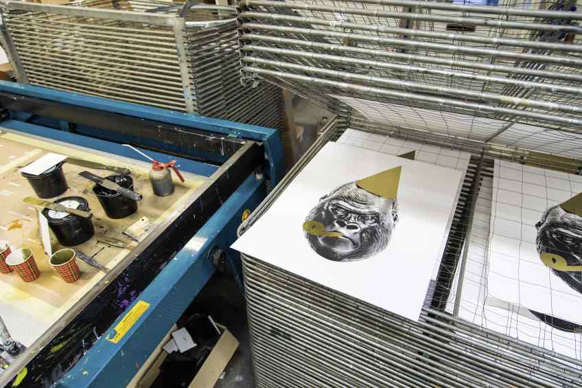 Multiple small Big Bang screen prints in a drying rack - Big Bang (edition, black/gold leaf), 2016 by Joseph Klibansky