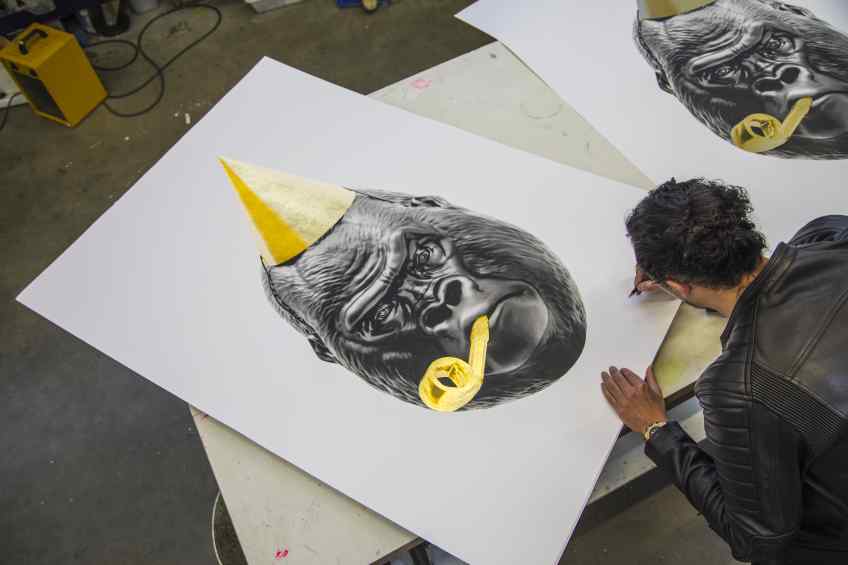 Joseph signing and numbering a large Big Bang screen print. - Big Bang (edition, black/gold leaf), 2016 by Joseph Klibansky