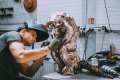 Studio assistant working on the bronze Thinker - The Thinker (bronze), 2018 by Joseph Klibansky