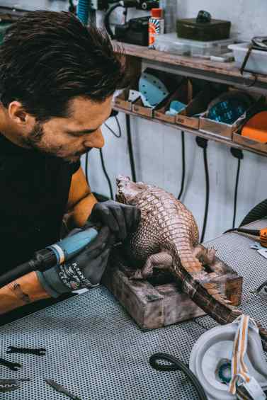 A studio assistent working on the sculpture "Happily Ever After" in Klibansky's Studio - Happily Ever After (bronze), 2018 by Joseph Klibansky